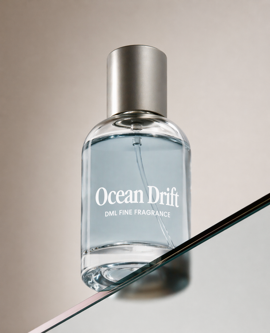 Perfume bottle labeled 'Ocean Drift' on a reflective surface with a neutral background